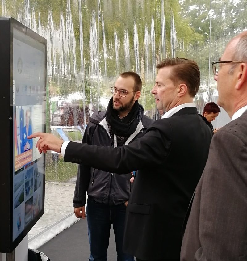 Government spokesman Steffen Seibert uses multitouch table to present social media activities of the federal ministries