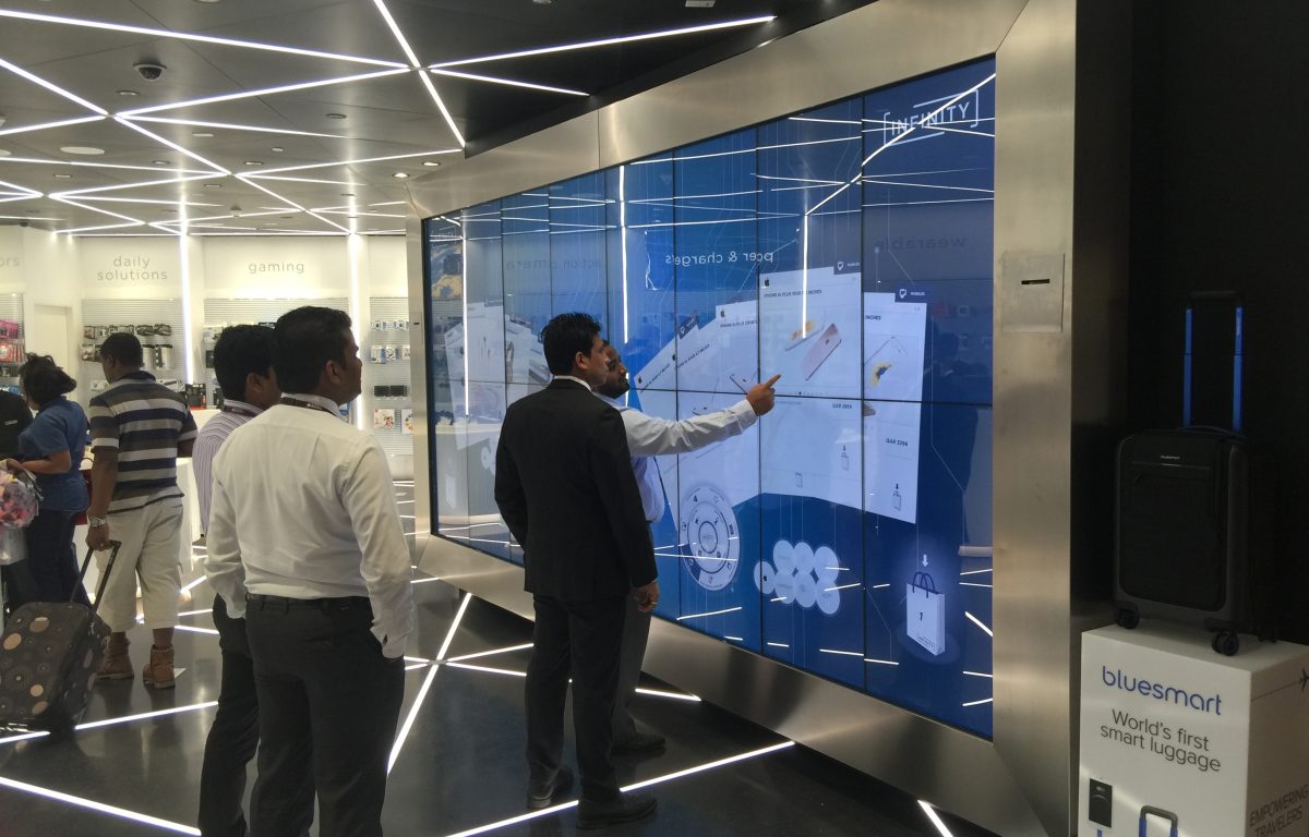 Customers in front of the interactive Shopping Wall