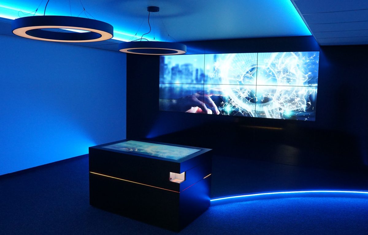 Multitouch table with screen wall in interactive showroom