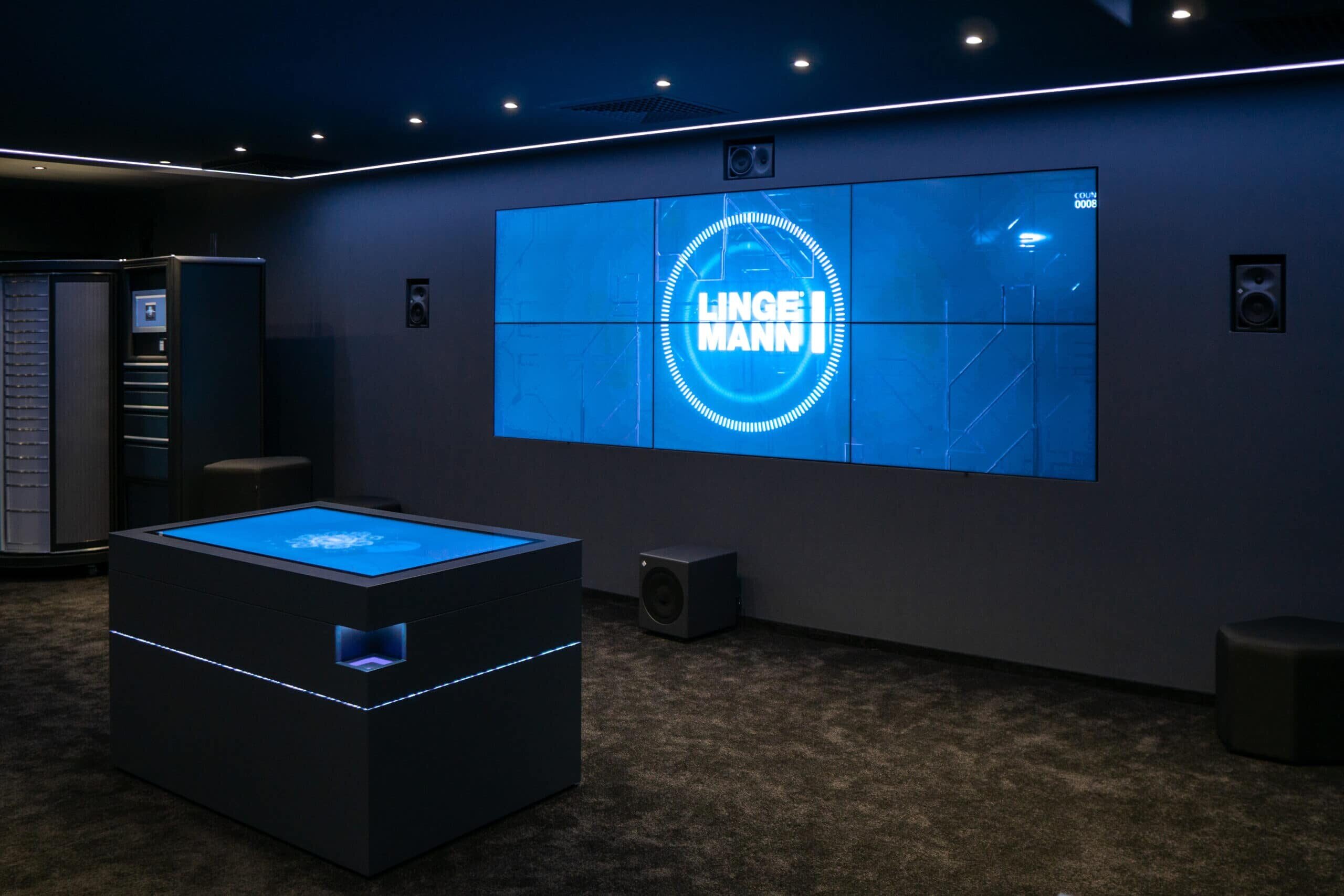 Lingemann Showroom mit Bildschirmwand und interaktivem Tisch zur Produktpräsentation