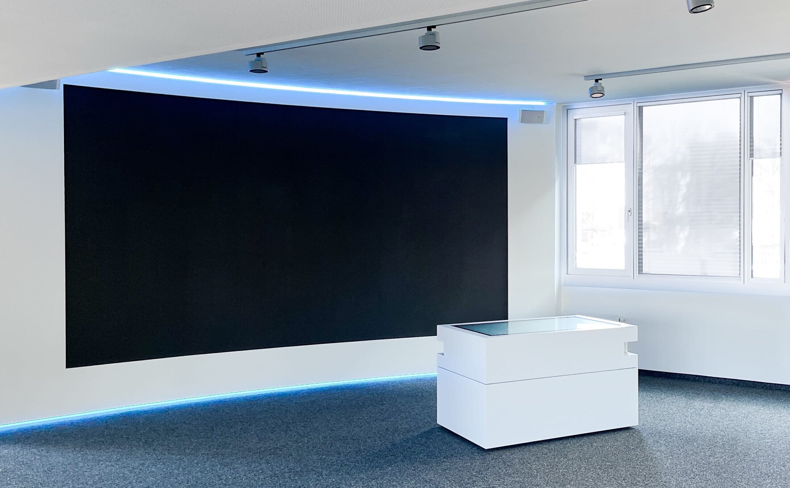 White multitouch table in front of LED wall in ESG showroom