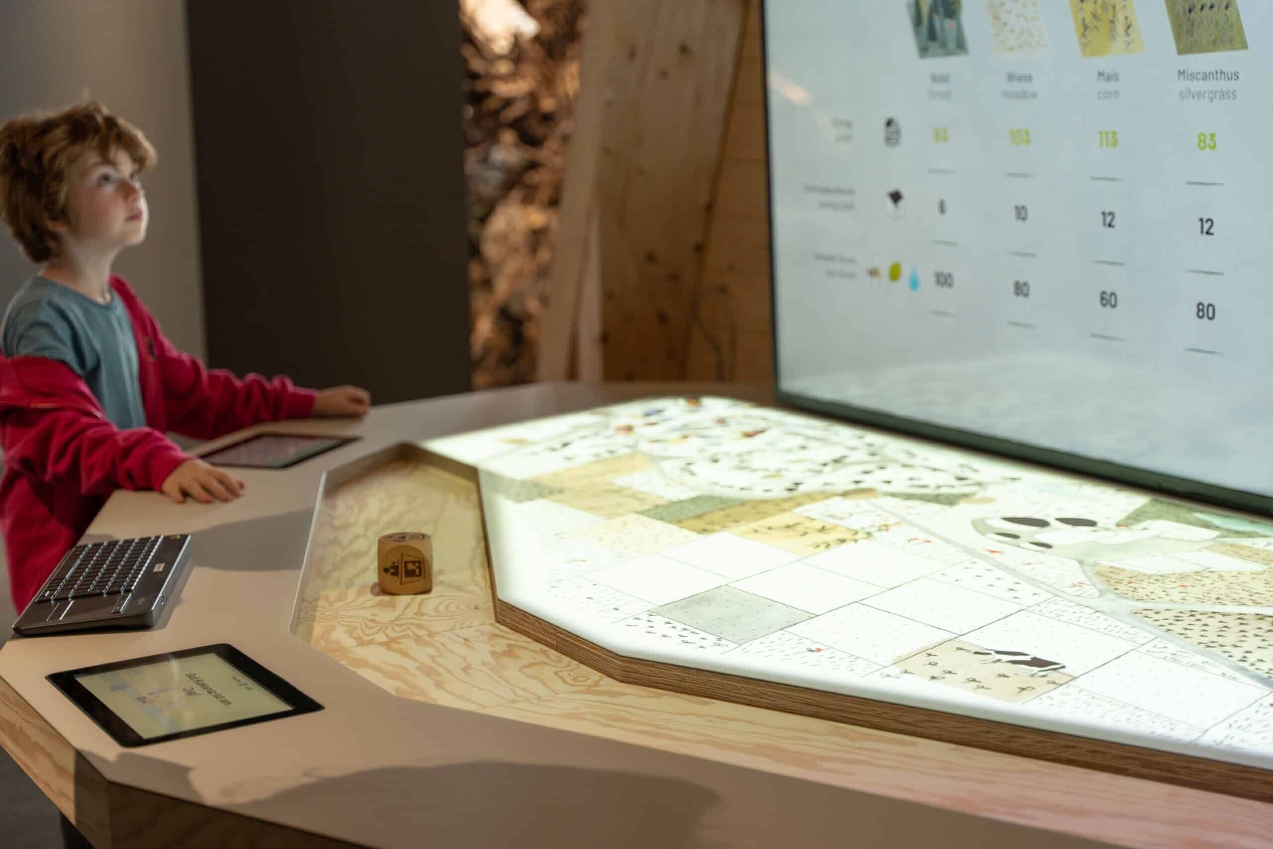 Interaktive Station im Museum mit Projektion, Bildschirm und Touchscreen